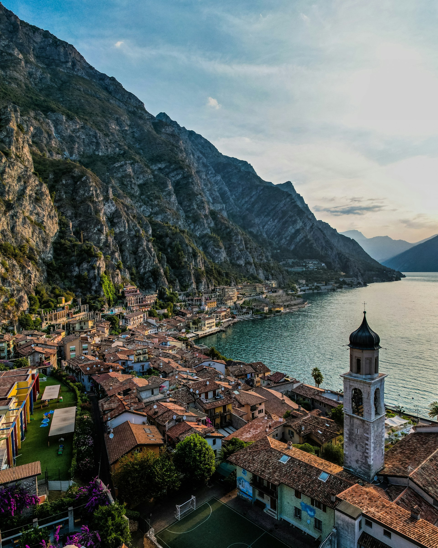 aerial photo of Limone Sul Garda with mountain and lake in the background