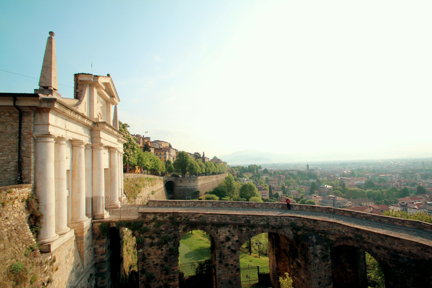 Bergamo upper city in focus with bridge and historic buildings